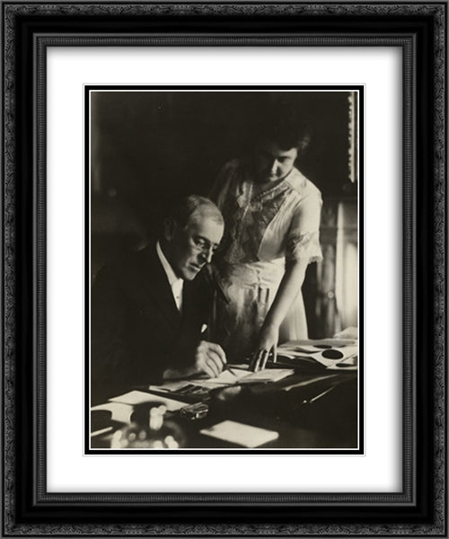 President Woodrow Wilson, seated at desk with his wife, Edith Bolling Galt, standing at his side 20x24 Black Ornate Wood Framed Art Print Poster with Double Matting by Library of Congress