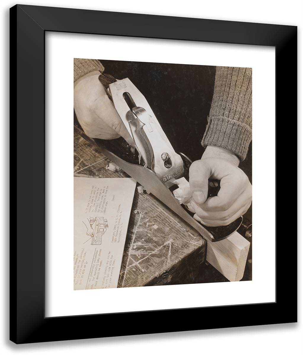 Man Uses a Wood Plane with an Instruction Booklet Sitting T 20x24 Black Modern Wood Framed Art Print Poster by Eagle, Arnold