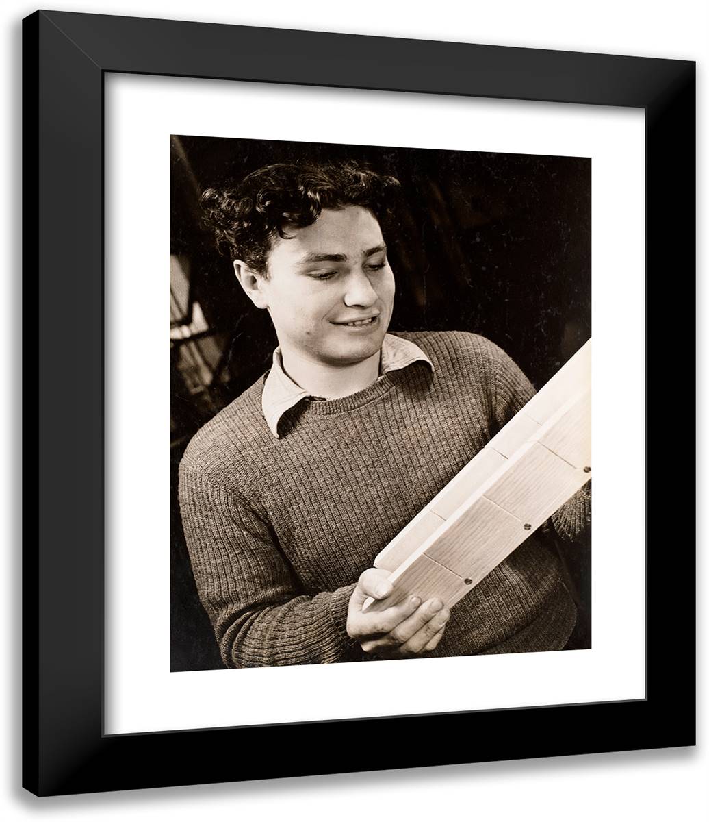 Young Man Looks Intently at a Piece of Wood 20x24 Black Modern Wood Framed Art Print Poster by Eagle, Arnold