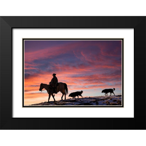 USA- Shell- Wyoming. Hideout Ranch cowgirl and her two dogs horseback riding at sunset. Black Modern Wood Framed Art Print with Double Matting by Gulin, Darrell