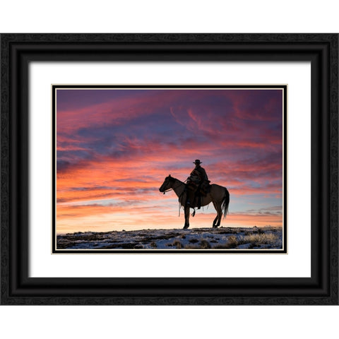 USA- Shell- Wyoming. Hideout Ranch cowgirl silhouetted on horseback at sunset. Black Ornate Wood Framed Art Print with Double Matting by Gulin, Darrell