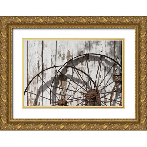 Old wagon wheels against a shed in Buffalo Gap Historic Village, near Abilene, TX Gold Ornate Wood Framed Art Print with Double Matting by Highmith, Carol