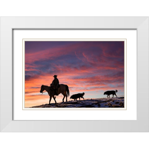 USA- Shell- Wyoming. Hideout Ranch cowgirl and her two dogs horseback riding at sunset. White Modern Wood Framed Art Print with Double Matting by Gulin, Darrell
