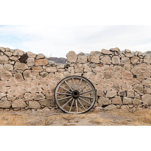 Wagon wheel against a stone fence at Hueco Tanks State Park, northwest of El Paso, TX White Modern Wood Framed Art Print by Highmith, Carol