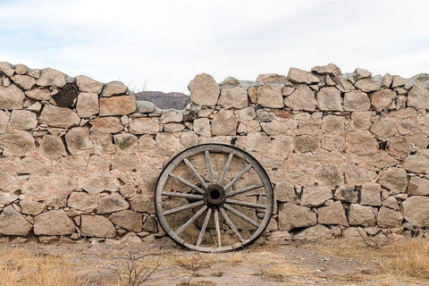 Wagon wheel against a stone fence at Hueco Tanks State Park, northwest of El Paso, TX Black Ornate Wood Framed Art Print with Double Matting by Highmith, Carol