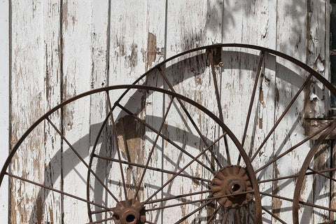 Old wagon wheels against a shed in Buffalo Gap Historic Village, near Abilene, TX White Modern Wood Framed Art Print with Double Matting by Highmith, Carol