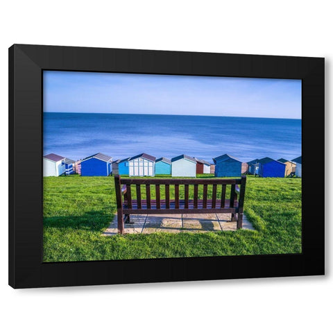 Bench on lawn with beach huts in background Black Modern Wood Framed Art Print by Frank, Assaf