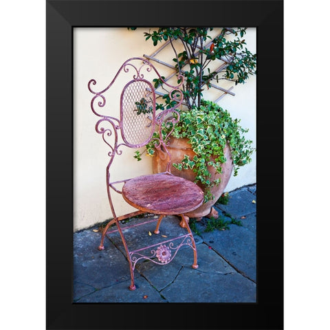 Italy-Tuscany-Lucca Decorative chair and potted plant outside a shop Piazza dellAnfiteatro Romano Black Modern Wood Framed Art Print by Eggers, Julie