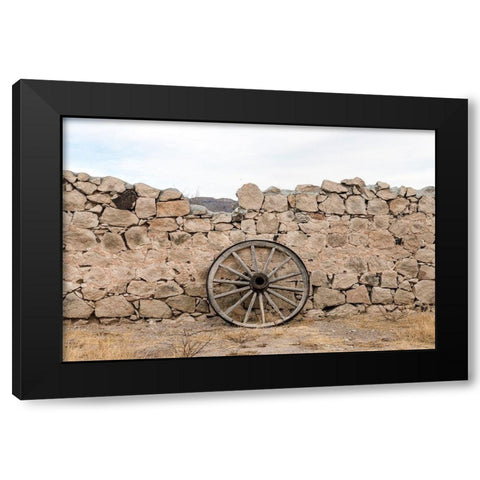 Wagon wheel against a stone fence at Hueco Tanks State Park, northwest of El Paso, TX Black Modern Wood Framed Art Print by Highmith, Carol