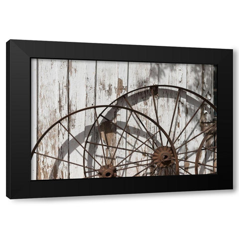 Old wagon wheels against a shed in Buffalo Gap Historic Village, near Abilene, TX Black Modern Wood Framed Art Print by Highmith, Carol