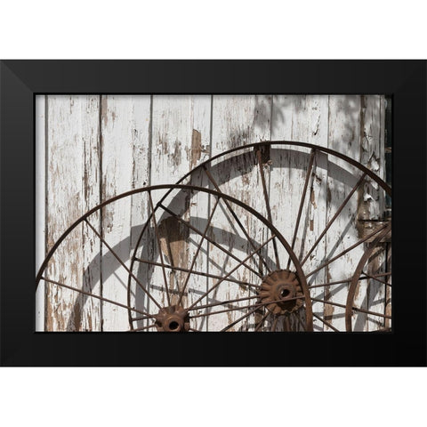 Old wagon wheels against a shed in Buffalo Gap Historic Village, near Abilene, TX Black Modern Wood Framed Art Print by Highmith, Carol