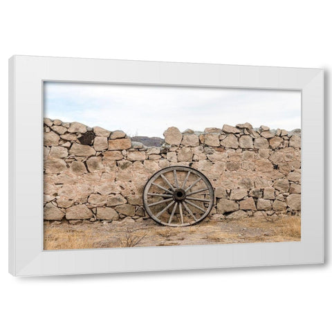 Wagon wheel against a stone fence at Hueco Tanks State Park, northwest of El Paso, TX White Modern Wood Framed Art Print by Highmith, Carol