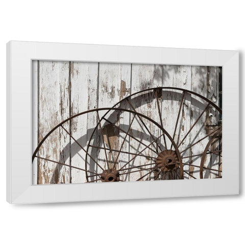 Old wagon wheels against a shed in Buffalo Gap Historic Village, near Abilene, TX White Modern Wood Framed Art Print by Highmith, Carol