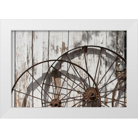 Old wagon wheels against a shed in Buffalo Gap Historic Village, near Abilene, TX White Modern Wood Framed Art Print by Highmith, Carol