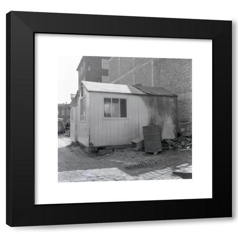 1960's Image Collection by Allan Cash Picture Library - Black Modern Wood Framed Art Print Titled: 1960s, historical, side-view of a workman's wooden hut, with windows, stacked on bricks on a cobbled area, England, UK. Outside a metal barre
