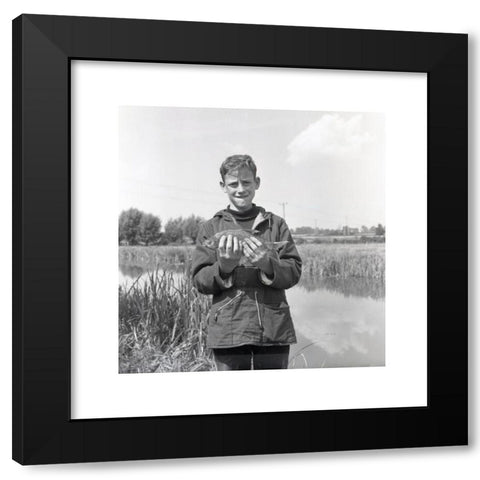 1960's Image Collection by Allan Cash Picture Library - Black Modern Wood Framed Art Print Titled: 1960s, historical, a teenage boy in a hooded top, side pockets and drawstring waist standing on a riverbank showing his catch, England, UK. T