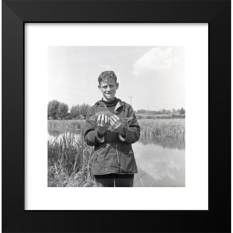 1960's Image Collection by Allan Cash Picture Library - Black Modern Wood Framed Art Print Titled: 1960s, historical, a teenage boy in a hooded top, side pockets and drawstring waist standing on a riverbank showing his catch, England, UK. T