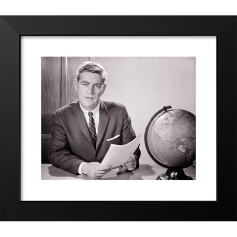 1960's Image Collection by ClassicStock - Black Modern Wood Framed Art Print Titled: 1960s MAN READING FROM DOCUMENT SEATED AT DESK WITH WORLD GLOBE LOOKING AT CAMERA TEACHER NEWSMAN ANNOUNCER BROADCASTER SPEAKER - s11506 HAR001 HARS JOURNA