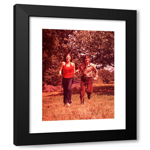 1960's Image Collection by ClassicStock - Black Modern Wood Framed Art Print Titled: 1960s YOUNG COUPLE RUNNING IN FIELD