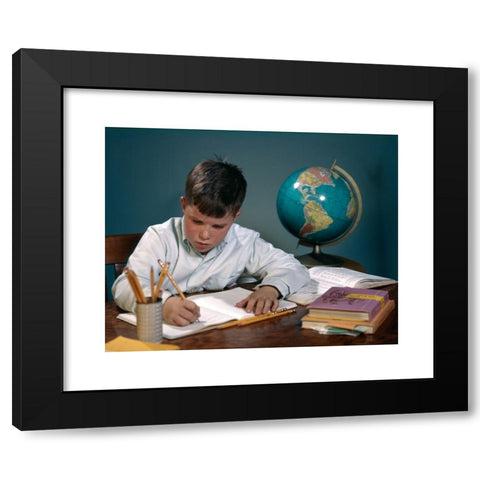 1960's Image Collection by ClassicStock - Black Modern Wood Framed Art Print Titled: 1960s 1970s BOY DOING HOMEWORK AT DESK WRITING NOTEBOOK BOOKS GLOBE