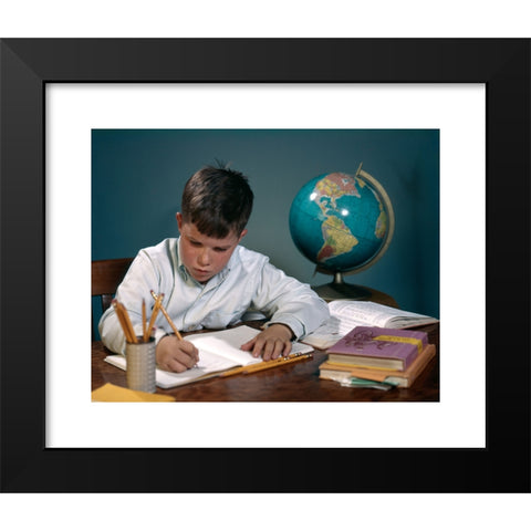 1960's Image Collection by ClassicStock - Black Modern Wood Framed Art Print Titled: 1960s 1970s BOY DOING HOMEWORK AT DESK WRITING NOTEBOOK BOOKS GLOBE