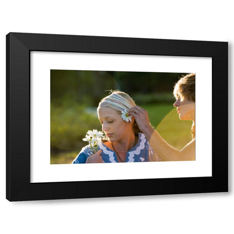 1960's Image Collection by Golden Pixels LLC - Black Modern Wood Framed Art Print Titled: View of a young couple in vintage 1960's hippie, putting flower behind ear