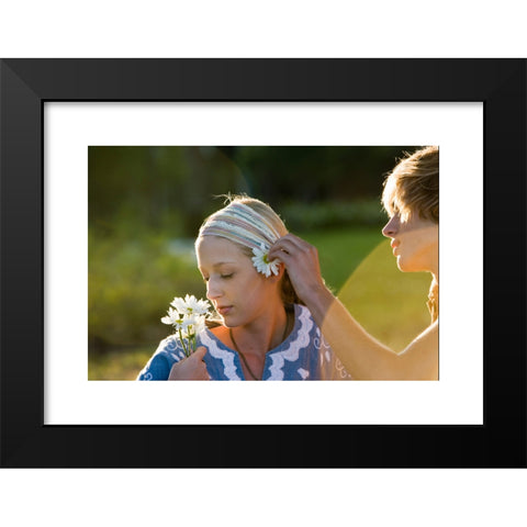 1960's Image Collection by Golden Pixels LLC - Black Modern Wood Framed Art Print Titled: View of a young couple in vintage 1960's hippie, putting flower behind ear