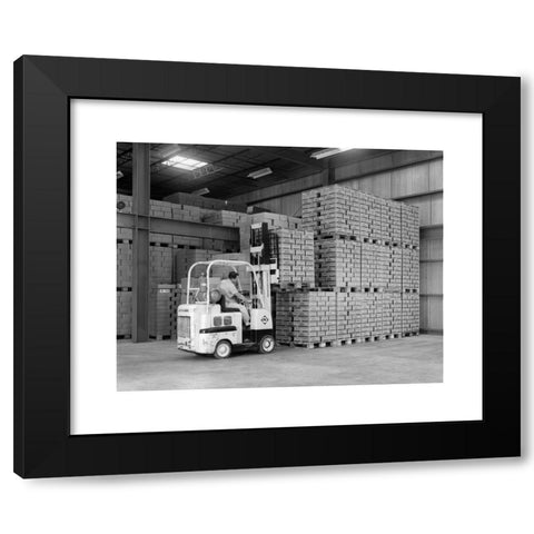 1960's Image Collection by ClassicStock - Black Modern Wood Framed Art Print Titled: 1960s WAREHOUSE MAN DRIVING FORKLIFT IN INSTANT COFFEE PLANT