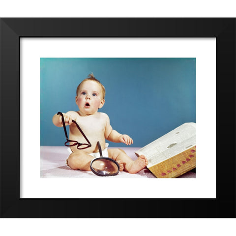 1960's Image Collection by ClassicStock - Black Modern Wood Framed Art Print Titled: 1960s BABY HOLDING EYEGLASSES WITH OPEN DICTIONARY AND MAGNIFYING GLASS RESEARCH