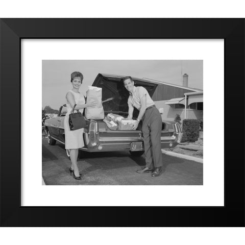 1960's Image Collection by ClassicStock - Black Modern Wood Framed Art Print Titled: 1960s COUPLE UNPACKING GROCERY BAGS FROM AUTOMOBILE TRUNK