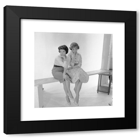 1960's Image Collection by Allan Cash Picture Library - Black Modern Wood Framed Art Print Titled: Historical picture from1960s. Two pretty young ladies sitting on a wooden plank in a photographic studio.