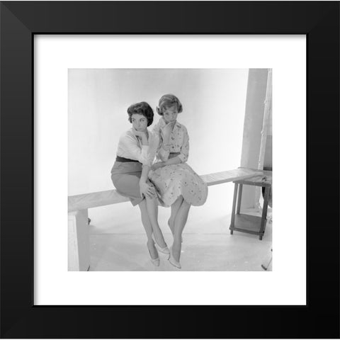 1960's Image Collection by Allan Cash Picture Library - Black Modern Wood Framed Art Print Titled: Historical picture from1960s. Two pretty young ladies sitting on a wooden plank in a photographic studio.