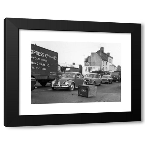 1960's Image Collection by Black Country Images - Black Modern Wood Framed Art Print Titled: Motorists avoiding a Chubb security safe which has fallen from a lorry Britain 1960s daylight robbery