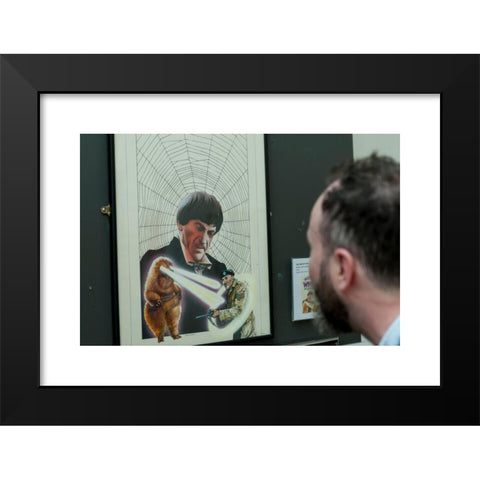 1960's Image Collection by Stephen Chung - Black Modern Wood Framed Art Print Titled: London, UK. 4 May 2016. A visitor views 'The Web of Fear' (1976), by the artist Chris Achilleos. Doctor Who: The Target Books Artwork exhibition, currentl