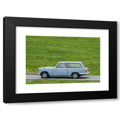 1960's Image Collection by Arterra Picture Library - Black Modern Wood Framed Art Print Titled: Elderly couple driving 1967 classic car Triumph Herald 1200 Estate along country road through meadow