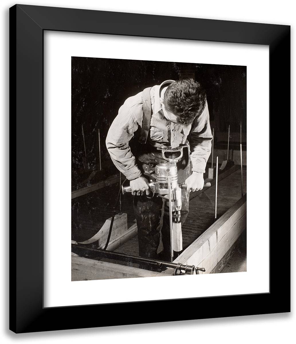 Man Uses a Handheld Machine to Work with a Piece of Wood 20x24 Black Modern Wood Framed Art Print Poster by Eagle, Arnold