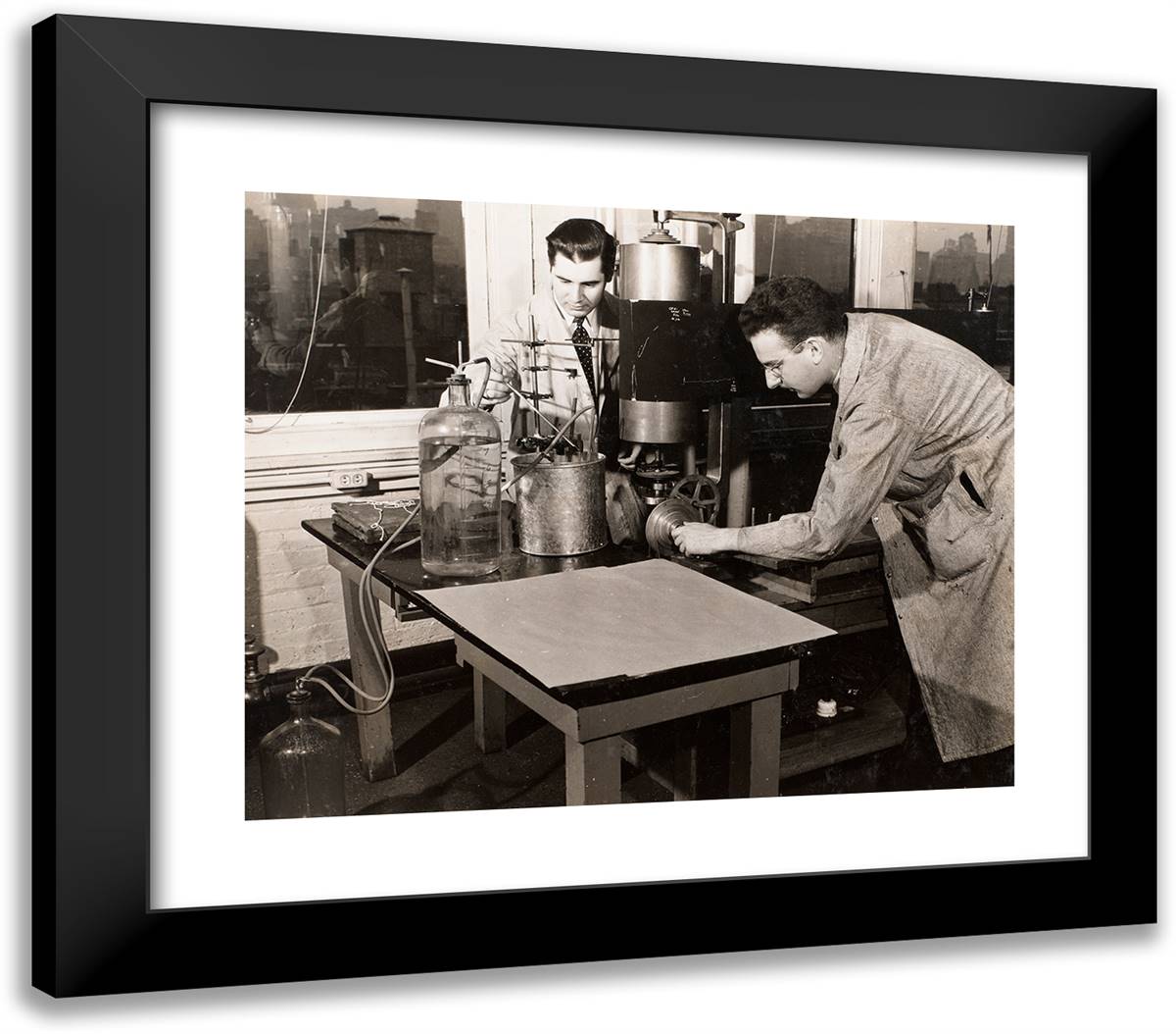 Two Men Stand Near a Table with a Large Machine and a Jug O 23x20 Black Modern Wood Framed Art Print Poster by Eagle, Arnold