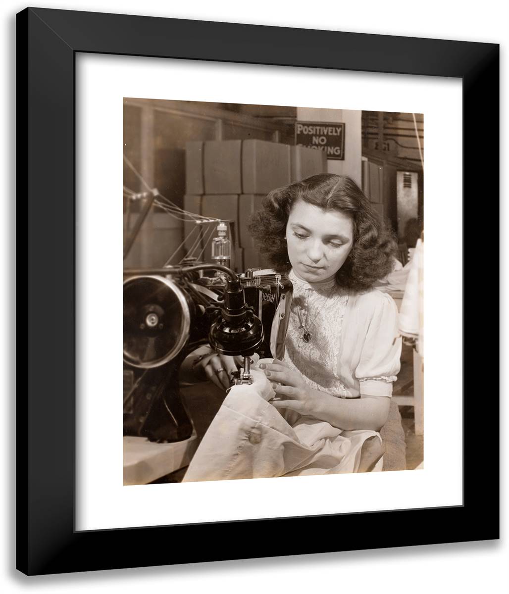 Woman Wearing a Heart-Shaped Necklace Uses a Sewing Machine 20x24 Black Modern Wood Framed Art Print Poster by Eagle, Arnold