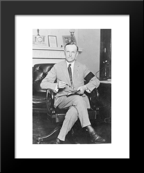 Calvin Coolidge, Full-Length Portrait, Seated At Desk, Facing Front, Holding Pen And Paper, Wearing Black Armband In Mourning For President Harding 20x24 Black Modern Wood Framed Art Print Poster by Library of Congress