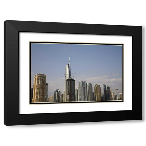 UAE, Dubai Construction amid skyscrapers Black Modern Wood Framed Art Print with Double Matting by Young, Bill
