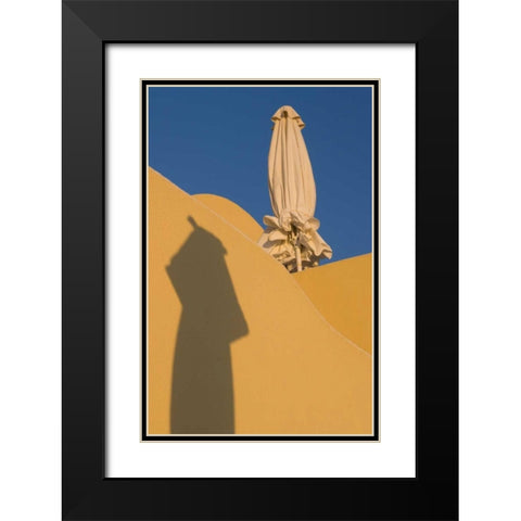 Greece, Santorini Sun umbrella against a wall Black Modern Wood Framed Art Print with Double Matting by Young, Bill