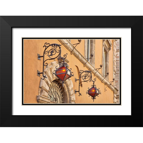Italy- Umbria- Assisi. Wrought iron dragon lights on a wall above an entrance. Black Modern Wood Framed Art Print with Double Matting by Eggers, Julie