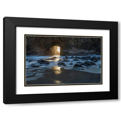 Sun shines through a tunnel in a sea cliff in the Big Sur area. Black Modern Wood Framed Art Print with Double Matting by Sederquist, Betty