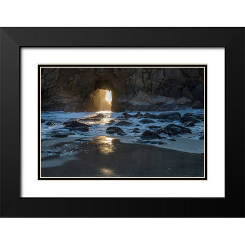Sun shines through a tunnel in a sea cliff in the Big Sur area. Black Modern Wood Framed Art Print with Double Matting by Sederquist, Betty