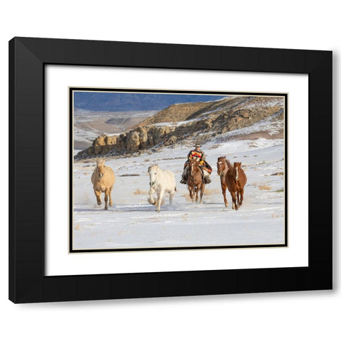 USA- Shell- Wyoming. Hideout Ranch cowboy riding and herding horses in snow.  Black Modern Wood Framed Art Print with Double Matting by Gulin, Darrell