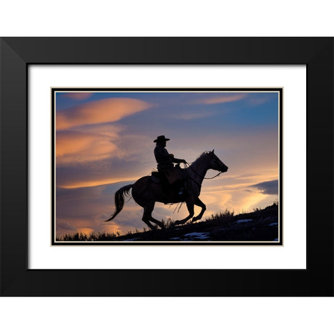 USA- Shell- Wyoming. Hideout Ranch cowboy on horseback silhouetted at sunset.  Black Modern Wood Framed Art Print with Double Matting by Gulin, Darrell
