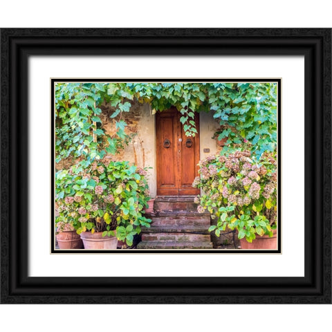 Italy-Tuscany-Pienza Doorway surrounded by flowers Black Ornate Wood Framed Art Print with Double Matting by Eggers, Julie