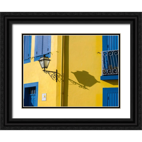 Portugal-Aveiro-Shadow of street lantern on colorful yellow building with bright blue shutters Black Ornate Wood Framed Art Print with Double Matting by Eggers, Julie