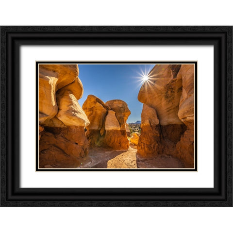 USA- Utah- Devils Garden Outstanding Natural Area. Sun starburst on hoodoo rock formations. Black Ornate Wood Framed Art Print with Double Matting by Jaynes Gallery