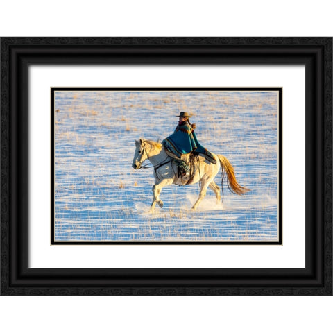 USA- Shell- Wyoming. Hideout Ranch cowgirl riding her horse in the snow.  Black Ornate Wood Framed Art Print with Double Matting by Gulin, Darrell
